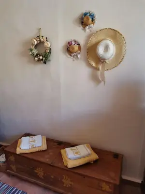 a room with a table and some wreaths on a wall at GIANNAS HOUSE in Symi