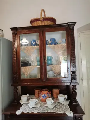 a cabinet with cups and dishes in it at GIANNAS HOUSE in Symi