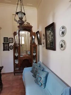 a living room with a blue couch and a mirror at GIANNAS HOUSE in Symi