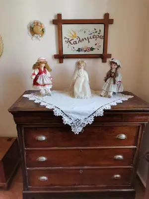 two dolls sitting on top of a dresser at GIANNAS HOUSE in Symi