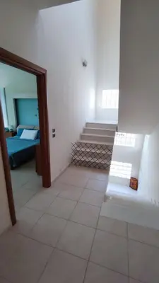 a room with a staircase and a room with a bed at Villa Katerina in Ialyssos