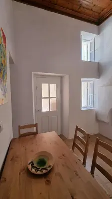 a dining room table with a plate on top of it at Kozas Art House, Symi in Symi