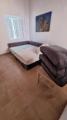 a bedroom with a bed and a table in it at Kozas Art House, Symi in Symi