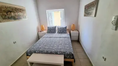 a small room with two beds and a window at Kozas Art House, Symi in Symi