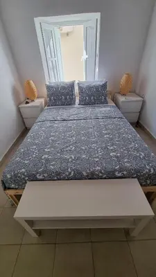 a large bed in a room with two twin beds at Kozas Art House, Symi in Symi