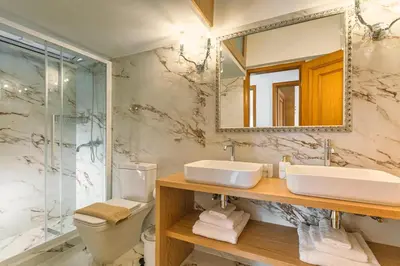 a bathroom with a sink and a toilet and a mirror at Casa di Flora Luxurious Apartment in Rhodes in Rhodes Town