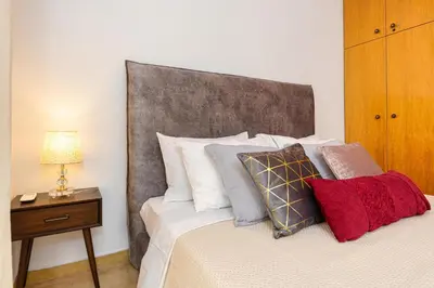 a bedroom with a bed with a large headboard at Casa di Flora Luxurious Apartment in Rhodes in Rhodes Town