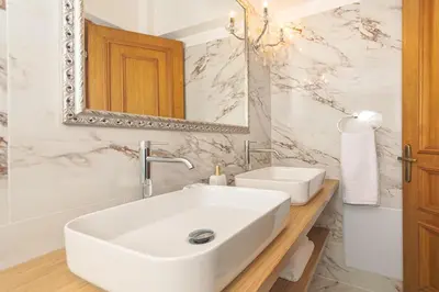 a bathroom with a white sink and a mirror at Casa di Flora Luxurious Apartment in Rhodes in Rhodes Town