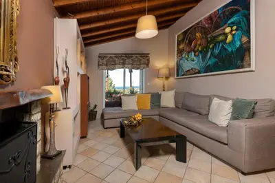 a living room with a couch and a table at Villa René in Koskinou