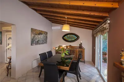 a dining room with a table and chairs at Villa René in Koskinou