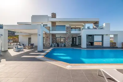 a villa with a swimming pool and a house at Alindo Villa I in Líndos