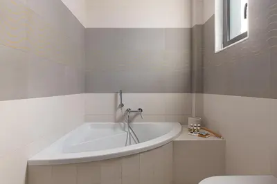a bathroom with a tub and a toilet at Alindo Villa I in Líndos
