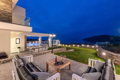 a patio with chairs and a table on a lawn at Alindo Villa I in Líndos