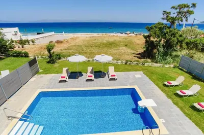 an overhead view of a swimming pool and the beach at Villa Rhodes Sea View by Villa Plus in Ixia