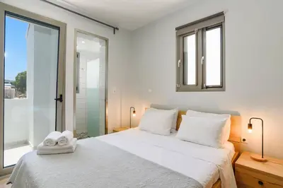 a bedroom with a white bed with towels on it at Villa Rhodes Sea View by Villa Plus in Ixia