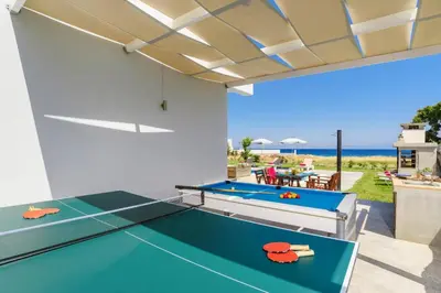 a living room with a ping pong table at Villa Rhodes Sea View by Villa Plus in Ixia