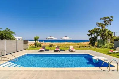 a swimming pool with a view of the beach at Villa Rhodes Sea View by Villa Plus in Ixia