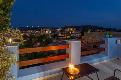 a view of a city from a balcony at night at Althea Apartments 1 in Halki