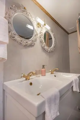 a bathroom with a white sink and a mirror at Philoxenia traditional house in Pastida