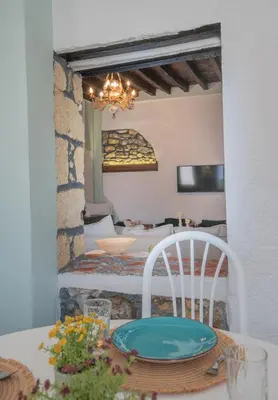 a room with a table with a plate on a chair at Philoxenia traditional house in Pastida