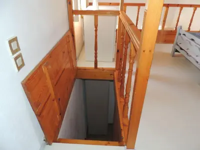 a wooden stair case in a room at Aloustina's House in Symi