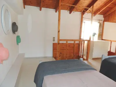 a bedroom with a bed in a room with wooden ceilings at Aloustina's House in Symi