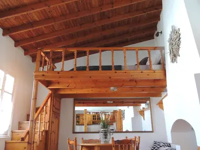 a room with a loft with a mirror at Aloustina's House in Symi
