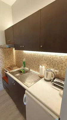 a kitchen with a sink and a counter top at Sea & Sun cozy studio in Kremasti