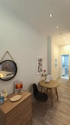 a living room with a table and a chair at Sea & Sun cozy studio in Kremasti