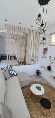 a living room with a couch and a table at Sea & Sun cozy studio in Kremasti