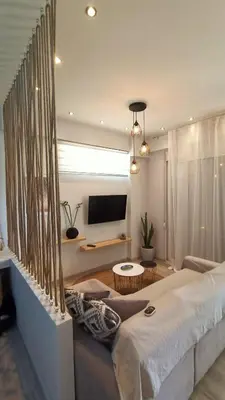 a living room with a large bed and a television at Sea & Sun cozy studio in Kremasti