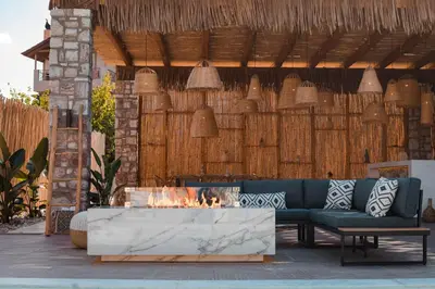 a patio with a couch and a fire pit at Le Ialyse Luxury Villa in Ialyssos