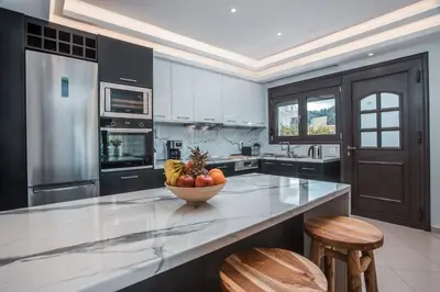 a kitchen with a bowl of fruit on a counter at Le Ialyse Luxury Villa in Ialyssos