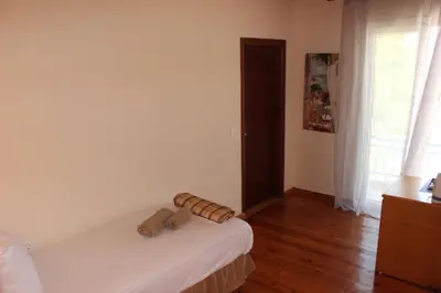 a bedroom with a bed with two logs on it at K Farm House in Kalavárda