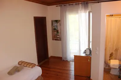 a small bedroom with a bed and a window at K Farm House in Kalavárda