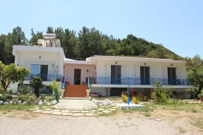 a white house with a hill in the background at K Farm House in Kalavárda