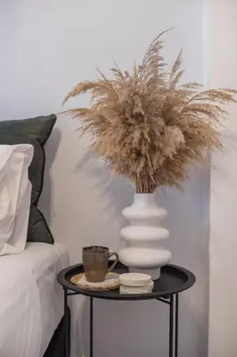 a table with a vase and a coffee cup on it at Inconceptual apartment in Paradeísion