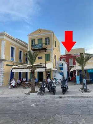 a group of motorcycles parked in front of a building at Green Symi Apartment in Symi