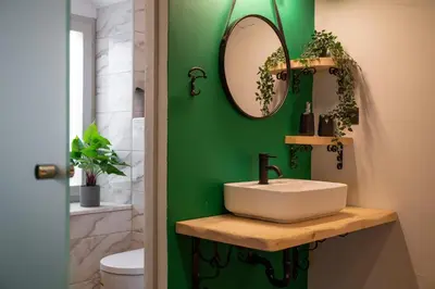 a bathroom with a sink and a green wall at Green Symi Apartment in Symi