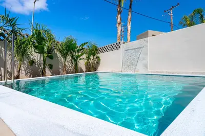 a swimming pool in a house with blue water at Pathos SeaSide Suites in Faliraki
