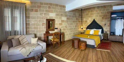 a room with a bedroom with a bed and a couch at Utopia Luxury Suites - Old Town in Rhodes Town