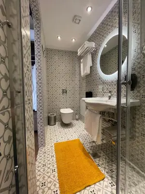 a bathroom with a sink and a mirror at Utopia Luxury Suites - Old Town in Rhodes Town