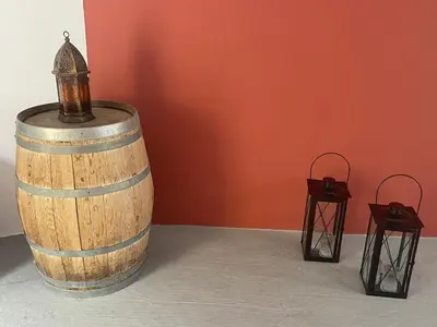 a wooden barrel with a lantern on top and two tables at Utopia Luxury Suites - Old Town in Rhodes Town