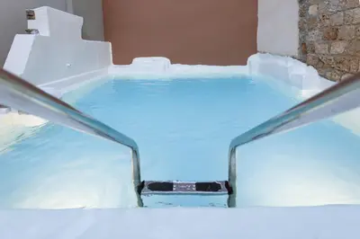 a hot tub in a room with snow and water at Utopia Luxury Suites - Old Town in Rhodes Town