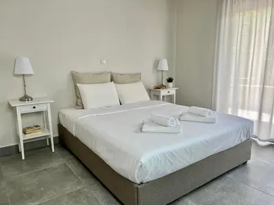 a bedroom with a large bed with towels on it at PETRA RESIDENCES IN LINDOS in Líndos