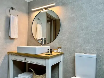 a bathroom with a sink and a mirror at PETRA RESIDENCES IN LINDOS in Líndos