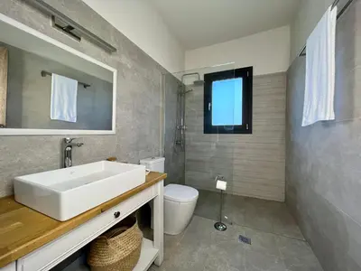 a bathroom with a sink and a toilet at PETRA RESIDENCES IN LINDOS in Líndos