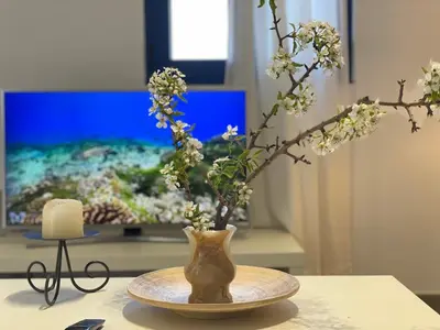 a vase with flowers in it sitting on a table at Ktima Tzaneti - Coastal Farmhouse in Lachania