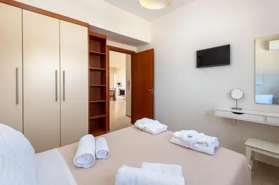 a room with a bed with towels on it at Diamond Hill Villa in Koskinou