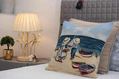 a bed with a pillow on a bed with a lamp at Antonia's Apartments in Archangelos